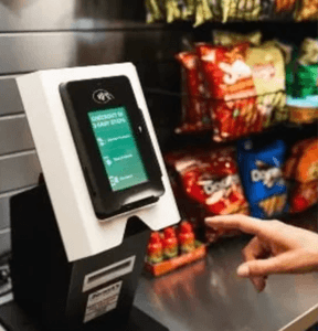 Guest completing a cashless payment at a smart checkout kiosk
